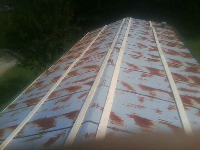 Rusted metal roof panels with new wood purlins before replacement — Storm Damage Roof Repair in Canyon Country by Roofing Brothers