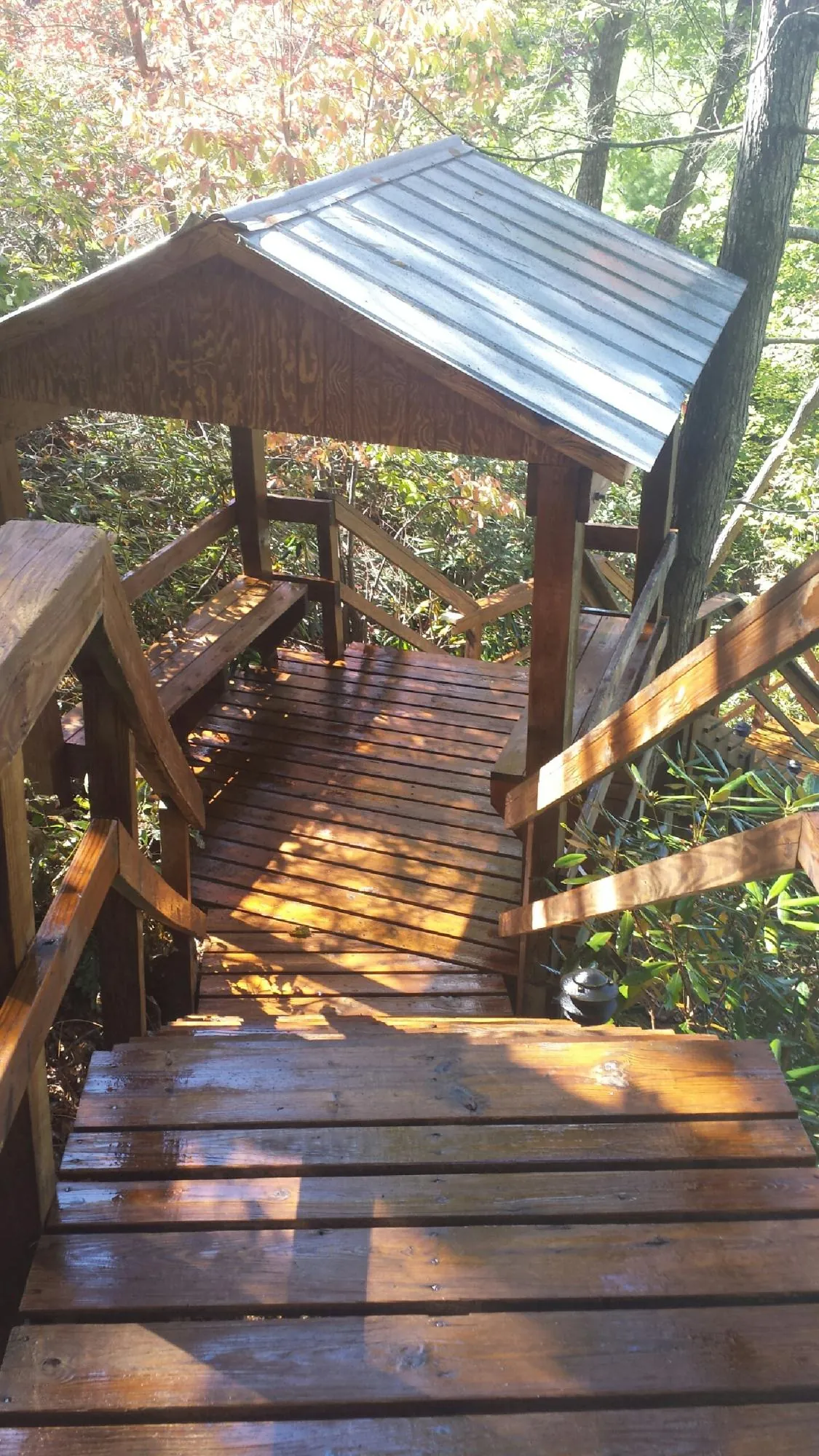 Freshly stained wood walkway and covered shelter with a metal roof in Canyon Country